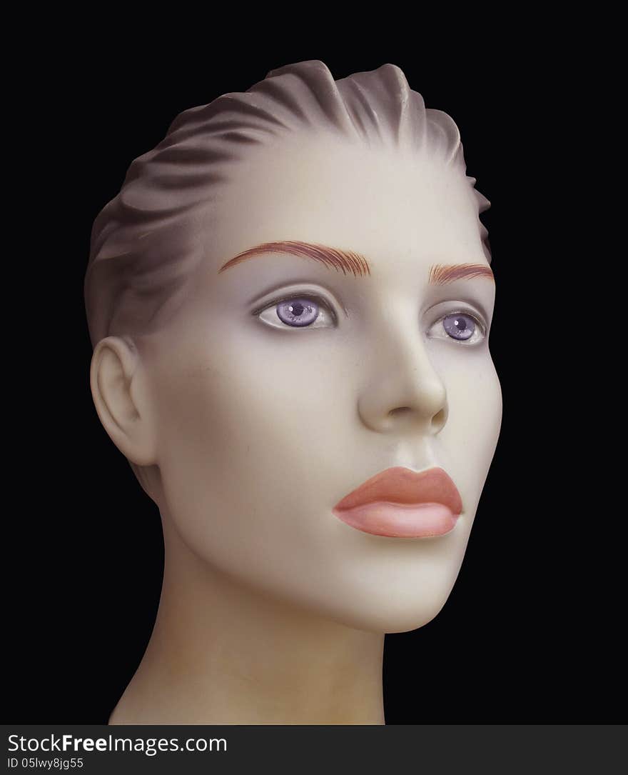 Close-up of the face of a female mannequin. Isolated on black. Close-up of the face of a female mannequin. Isolated on black.