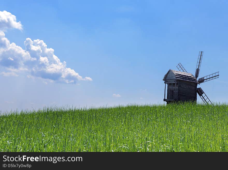 Scenic rural agriculture green field old windmills