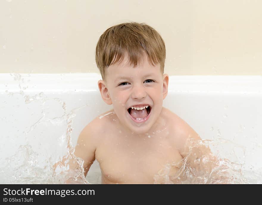 Cute three year old boy taking a bath with foam. Cute three year old boy taking a bath with foam