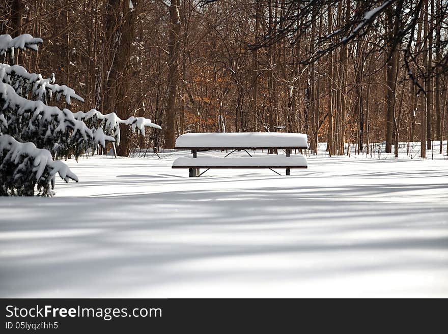 The picnictable under deep layer of snow in the park