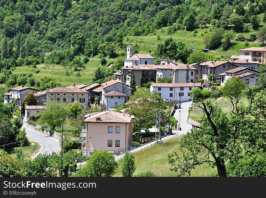 Image shows typical italian village Voltino within the national park of Tremosine, Italian. Village is surrounded by mountains, trees and meadows. Image shows typical italian village Voltino within the national park of Tremosine, Italian. Village is surrounded by mountains, trees and meadows.