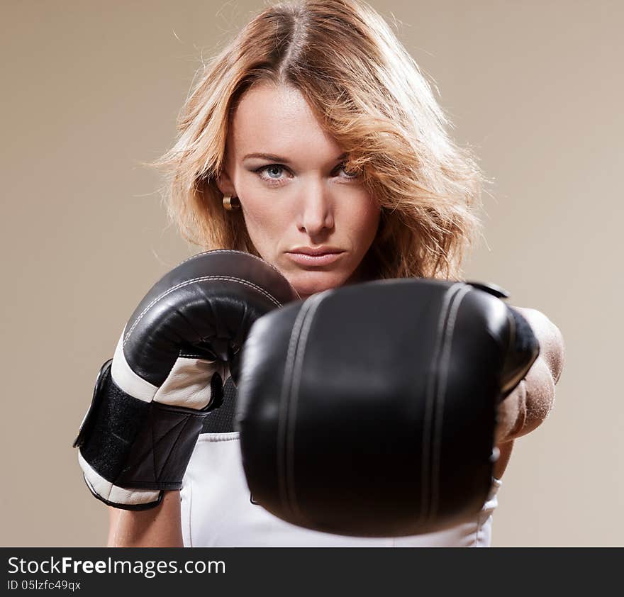 Portrait of blonde sportish woman in boxing gloves. Portrait of blonde sportish woman in boxing gloves