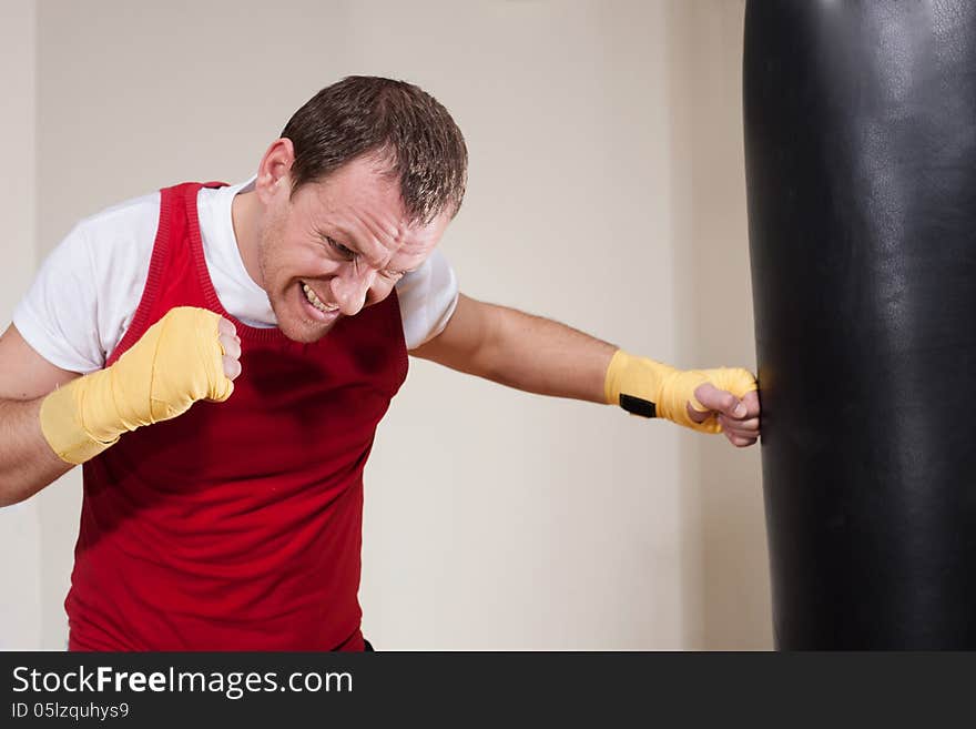 Man Makes Exercises With Punching Bag