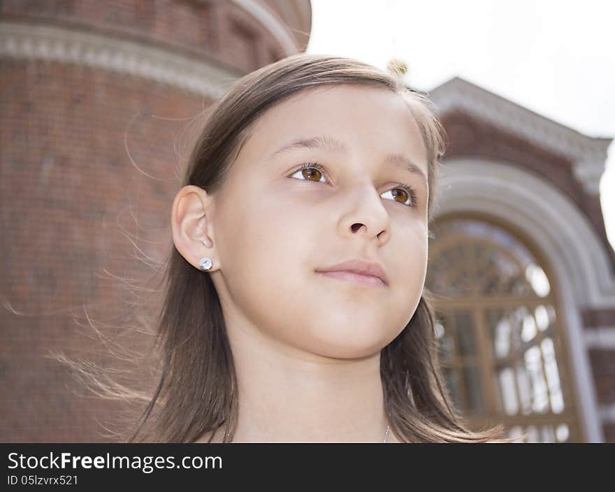 Portrait of the girl against a cathedral.