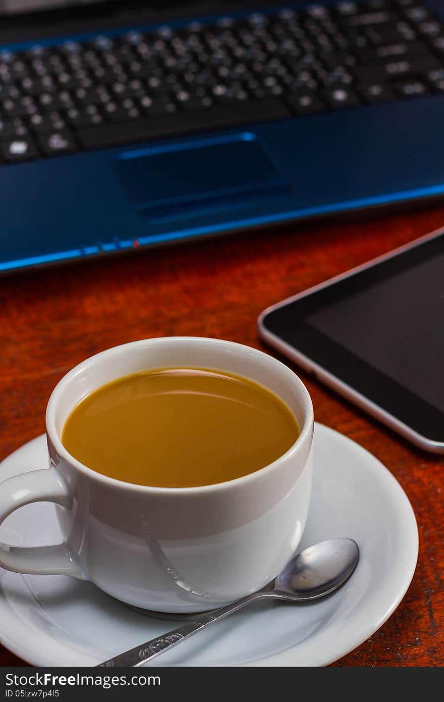 Coffee cup and Laptop on wooden table. Coffee cup and Laptop on wooden table