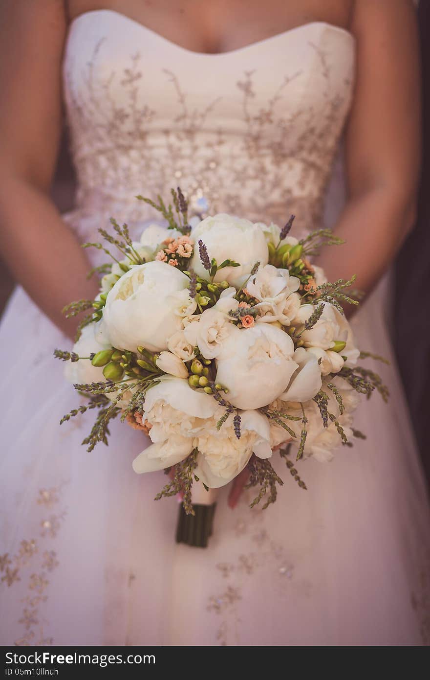 Wedding Bouquet Of Flowers Held By A Bride