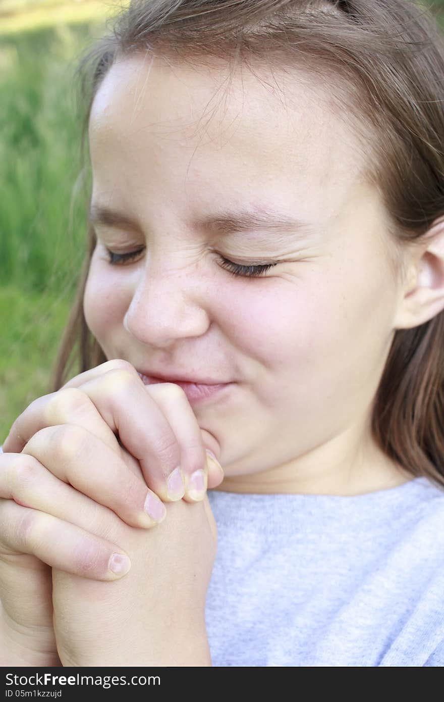 Young Girl squinting hard with hands squeezed tight. Young Girl squinting hard with hands squeezed tight.