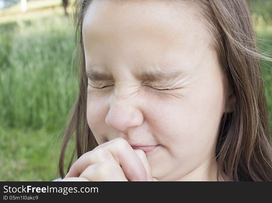 Young Girl squinting hard with hands squeezed tight. Young Girl squinting hard with hands squeezed tight.