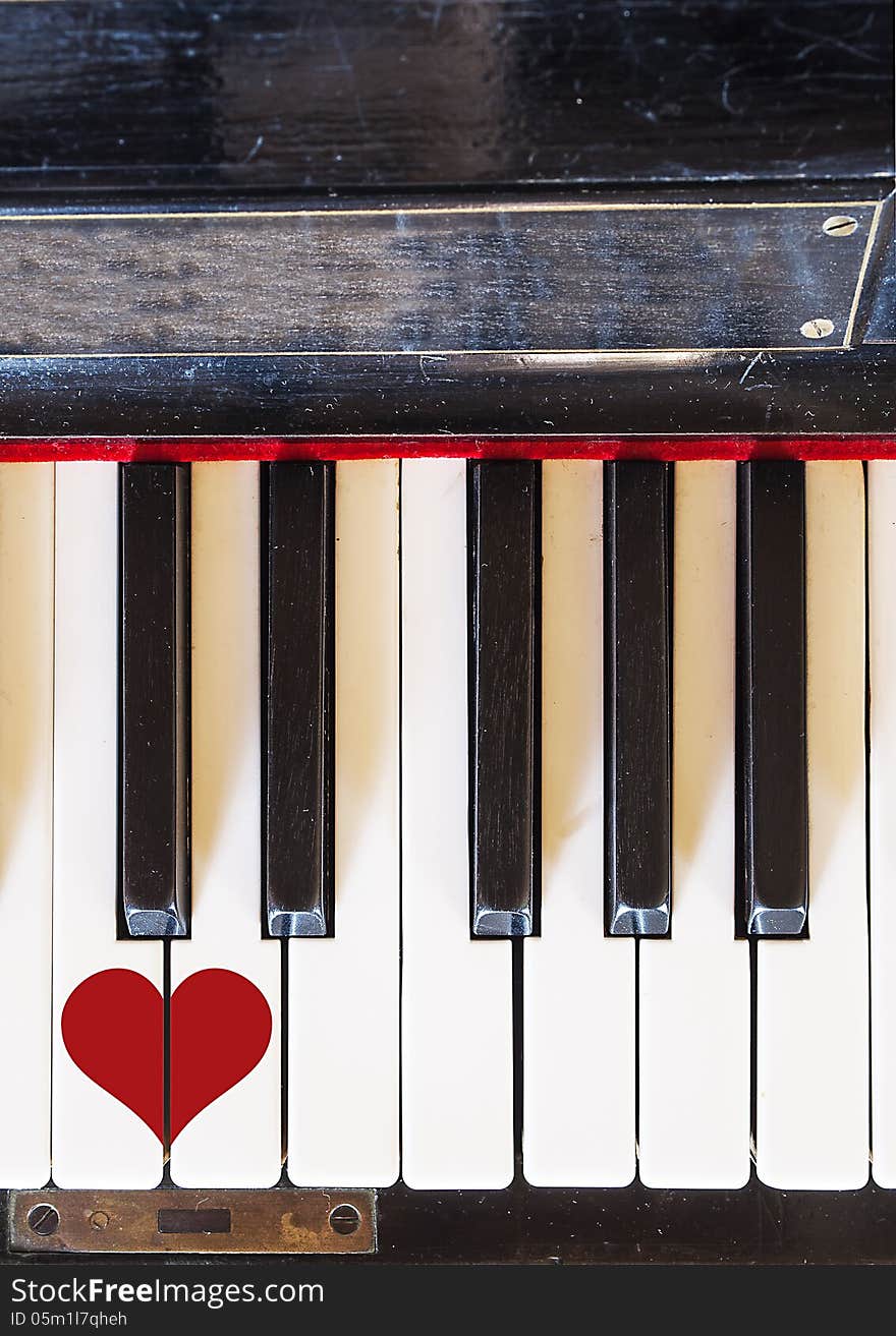 Piano keyboard top view with a painted heart. Piano keyboard top view with a painted heart