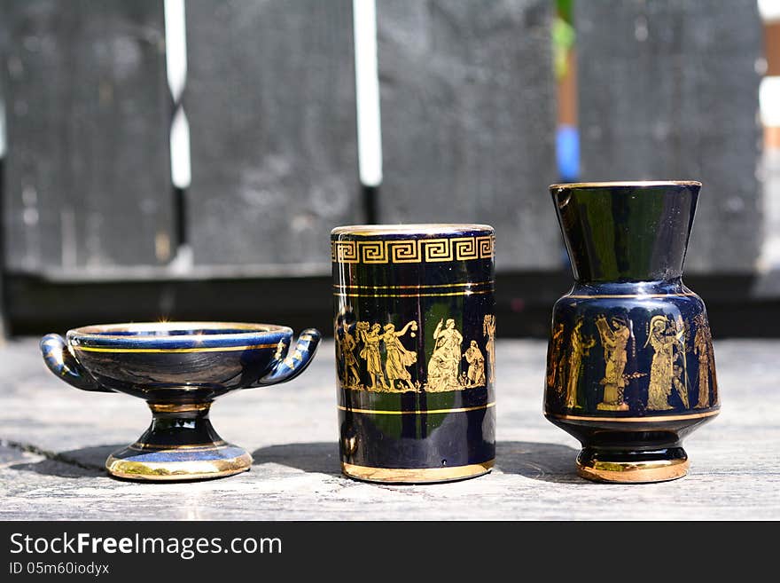 Cup and an urn with Greek motifs. Cup and an urn with Greek motifs