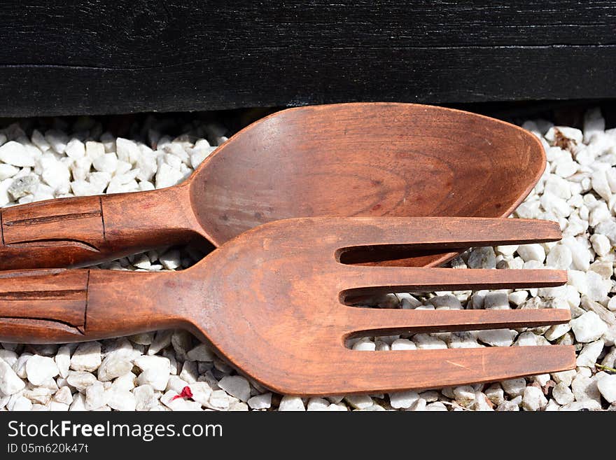 Wooden spoons on stones in the sun