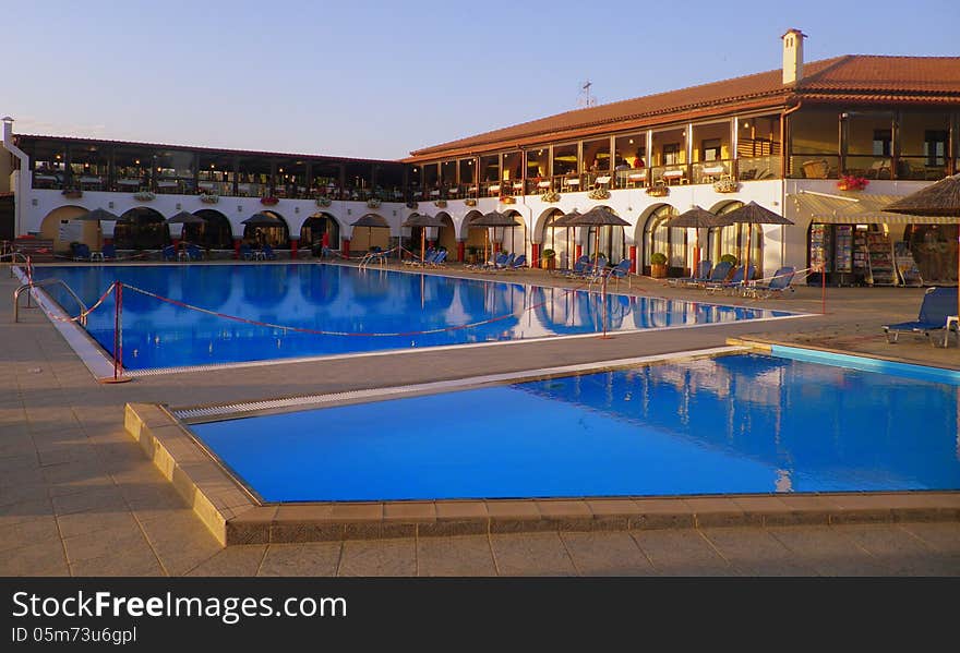 Image of a resort pool beside the hotel. Image of a resort pool beside the hotel