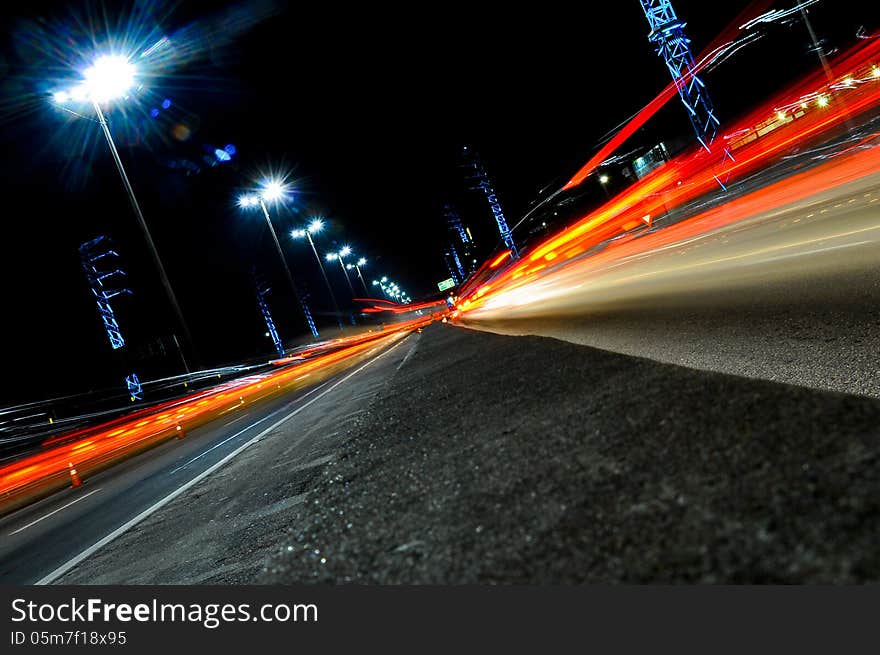 Red car light trails in highway. Red car light trails in highway.