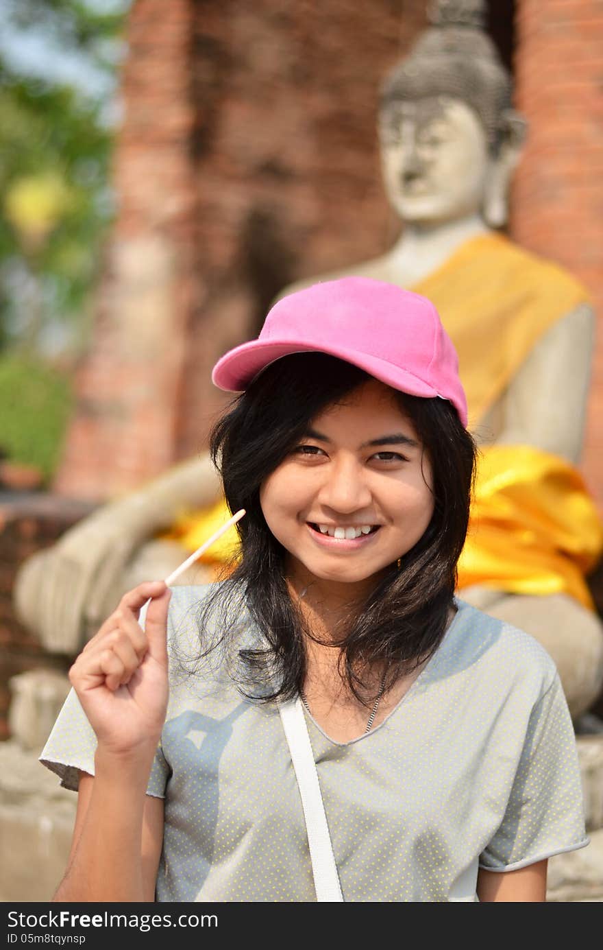 Young girl and buddha at Wat Yai Chai Mongkol Temple