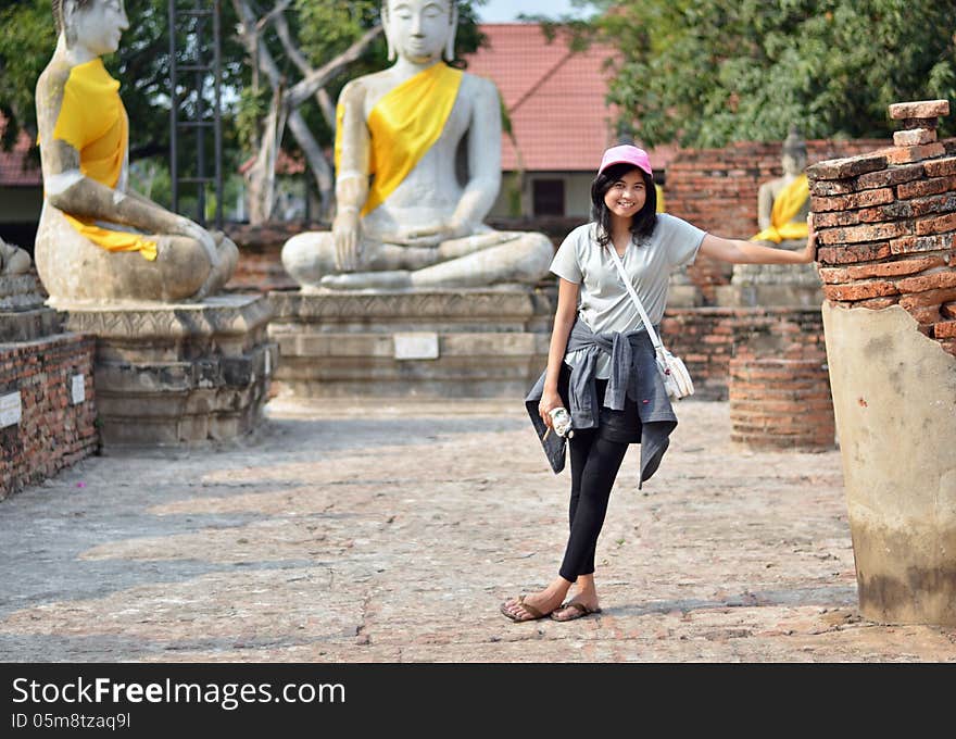 Asian woman and buddha at Wat Yai Chai Mongkol Temple. Ayutthaya