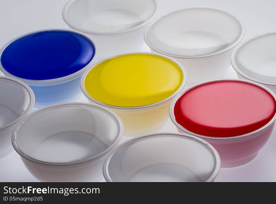 Plastic cups with yellow, blue and red color on white background. Plastic cups with yellow, blue and red color on white background