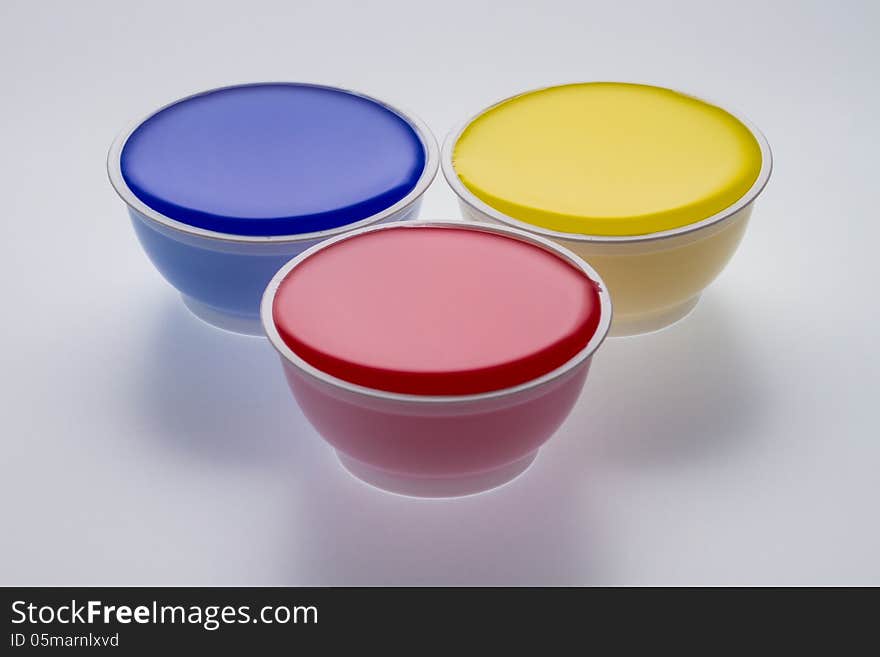 Plastic cups with yellow, blue and red color isolated on a white background. Plastic cups with yellow, blue and red color isolated on a white background