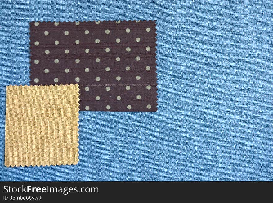 Pieces of fabric brown polka dots and light brown on blue fabric