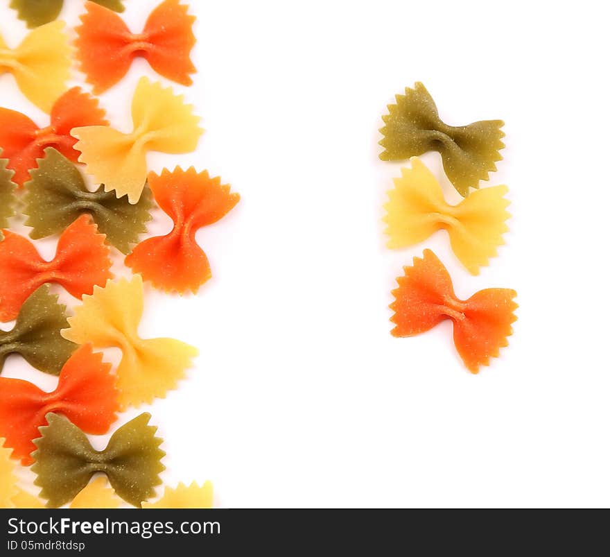 A composition of different pasta in three colors on the white background. A composition of different pasta in three colors on the white background.