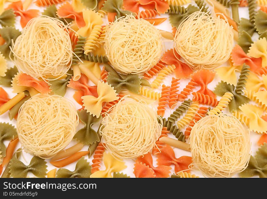 A different pasta in three colors on the white background. A different pasta in three colors on the white background.