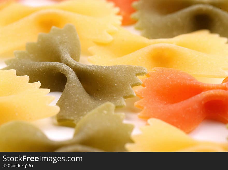 A background of the farfalle pasta three colors close-up.