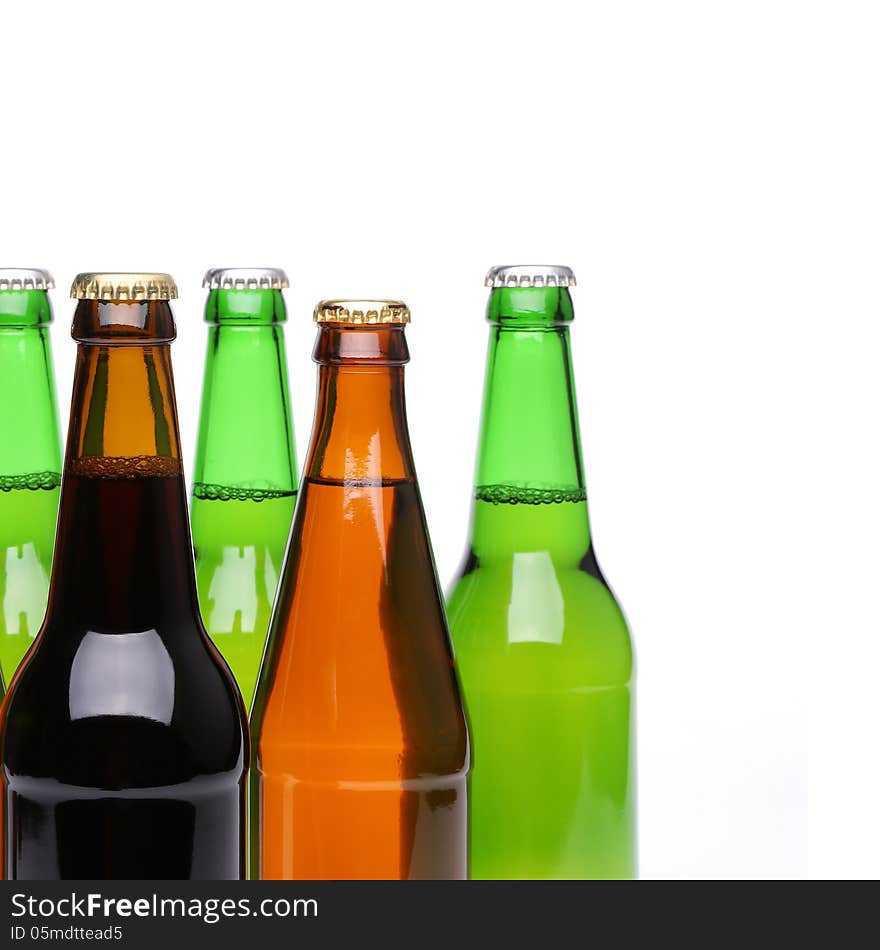 Closed bottles of beer are located left on a white background. Closed bottles of beer are located left on a white background