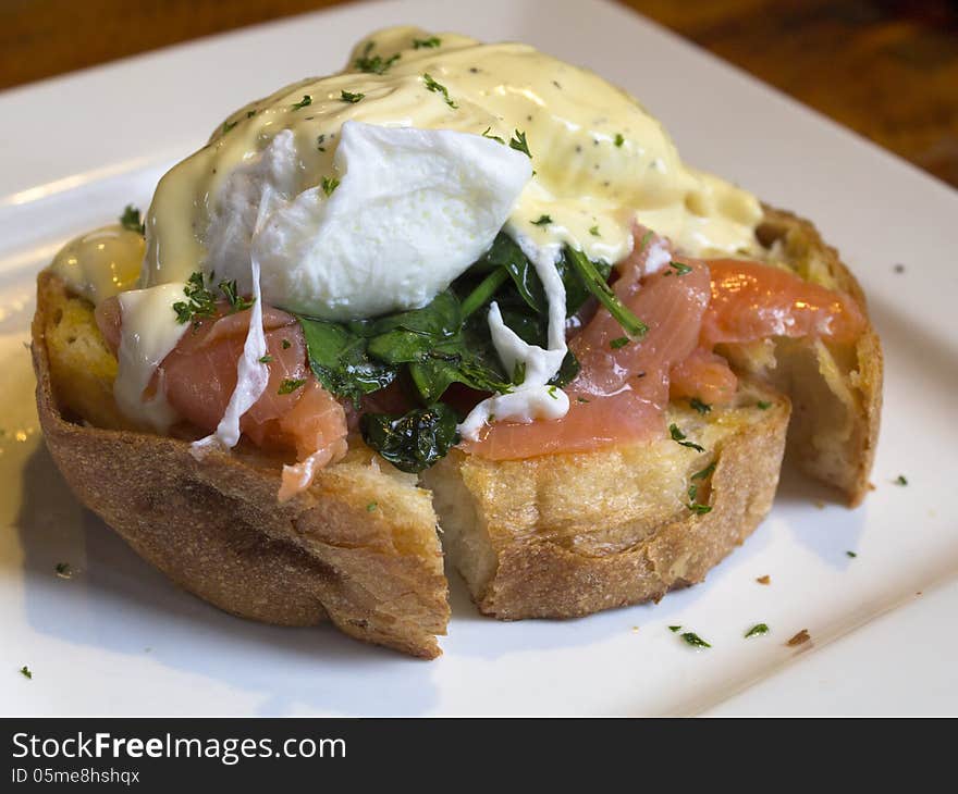 Egg benedict with salmon and spinach close up