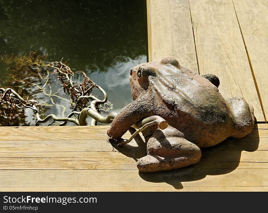 Private pond with sculpture of frog. Private pond with sculpture of frog.