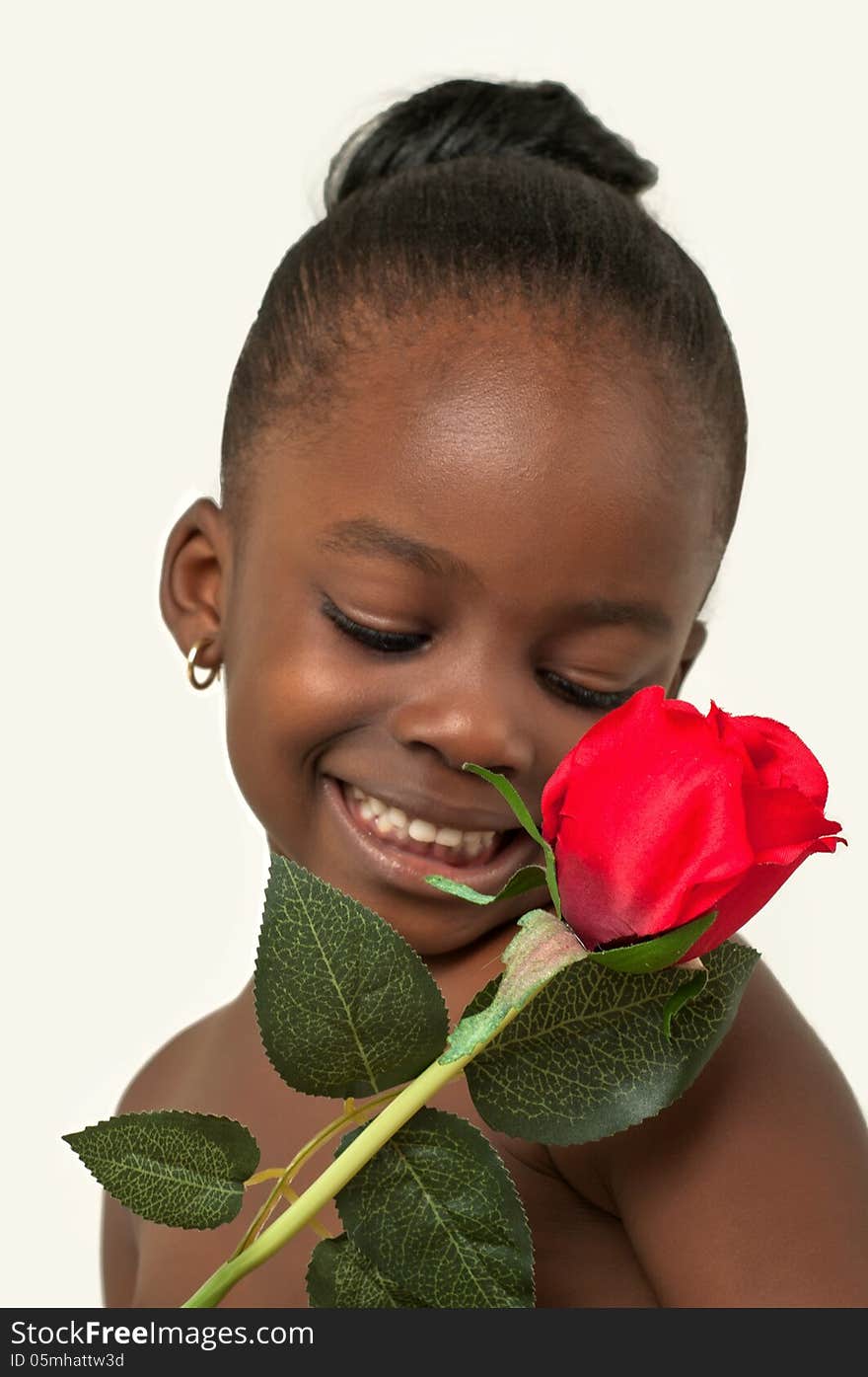 Beautiful little girl with red rose