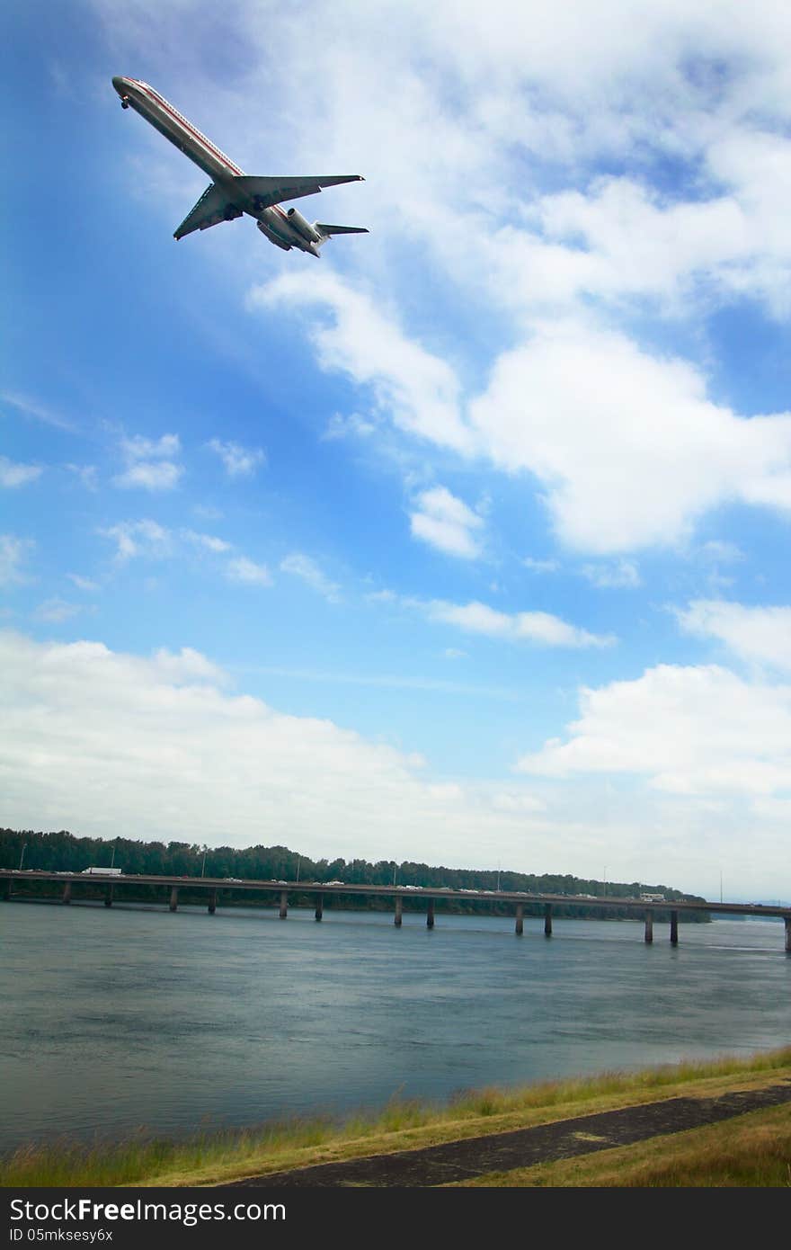 A plane flys over the Glenn Jackson Memorial Bridge connecting Oregon to Government Island and then on to Washington state, spanning the Columbia River. A plane flys over the Glenn Jackson Memorial Bridge connecting Oregon to Government Island and then on to Washington state, spanning the Columbia River