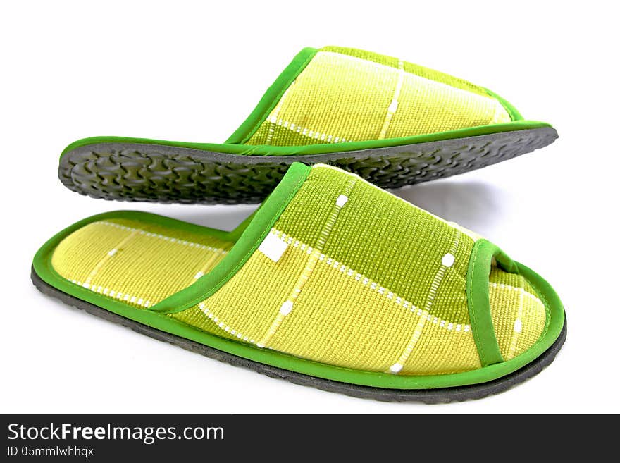 Green cloth slippers on a white background