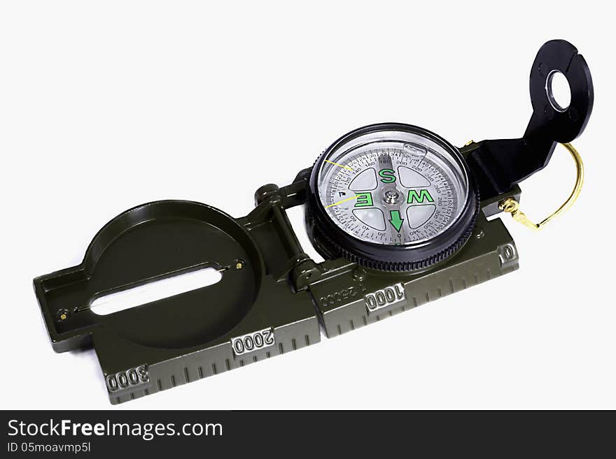 A small compass in a metal frame on a white background.