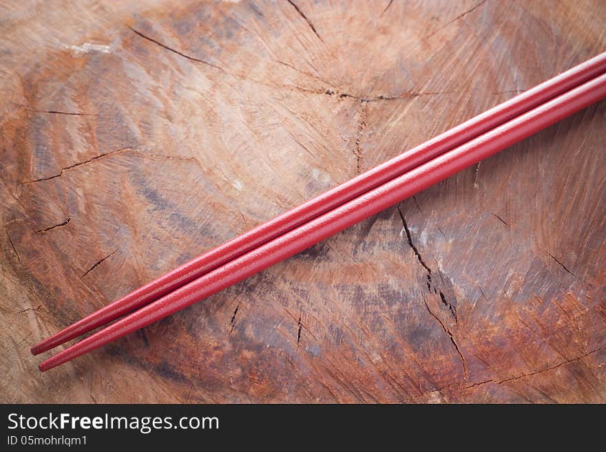 Two chopsticks next to and wood