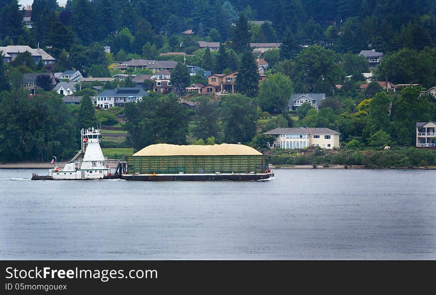 Tugboat Pushing a Full Heavy Barge