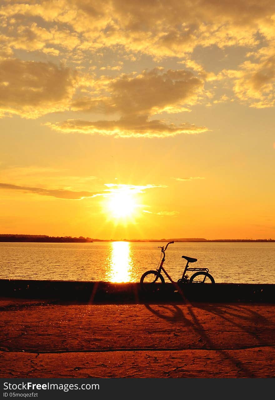 Bicycle by the lake at sunset