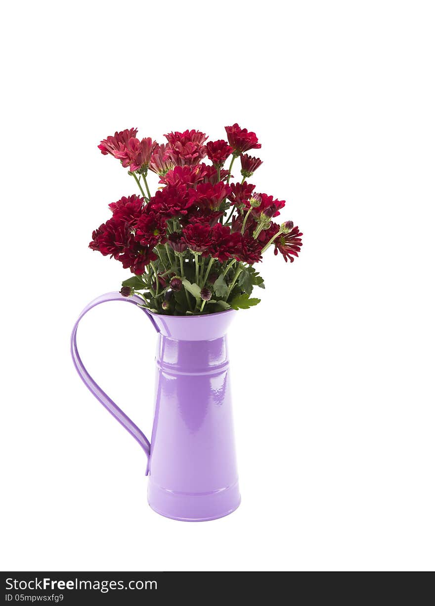 Red flowers and a purple flagon on a white background.