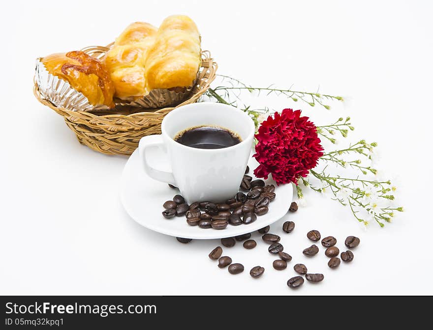 A cup of coffee and bakeries in basket on white background.