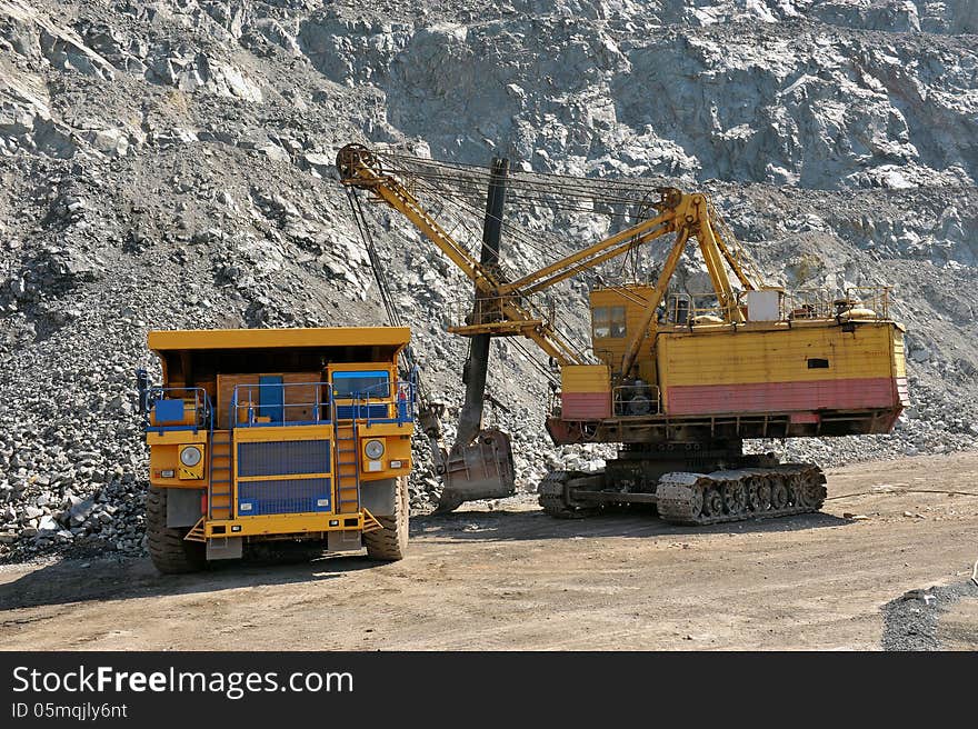 Loading of iron ore on very big dump-body truck