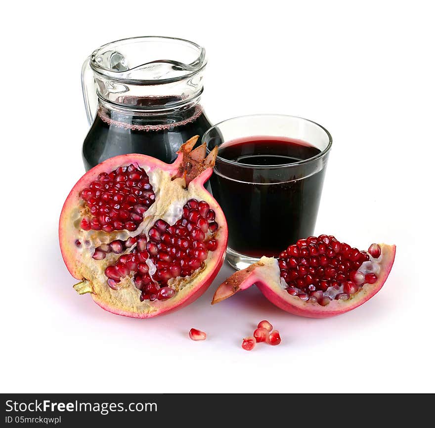 Jug of juice and ripe piece grenade on white background