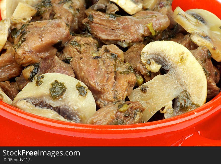 Beef Stew with Greens and Champignons closeup in Red Pan