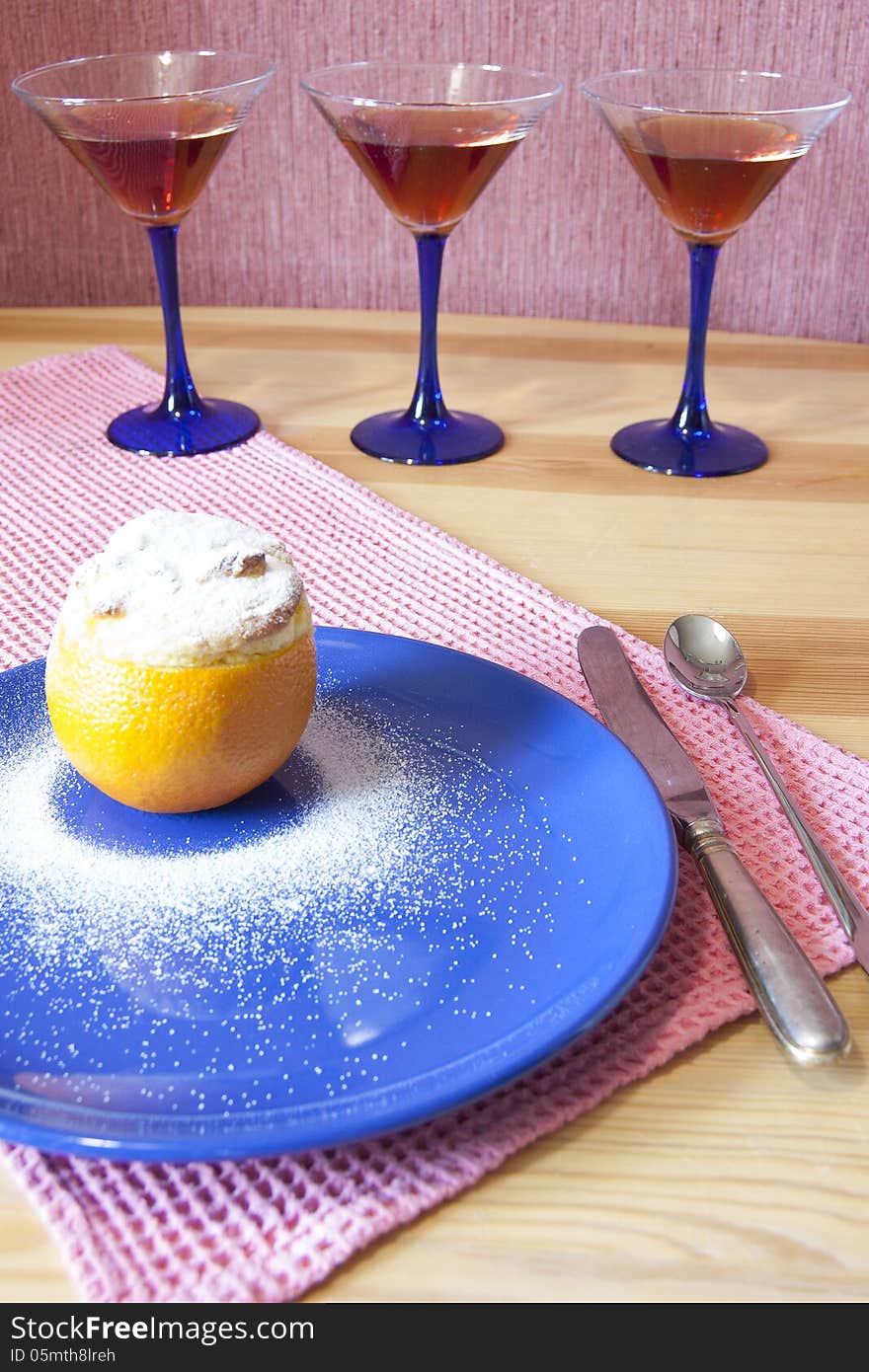 Orange dessert served with a knife, a spoonon and martini glass. Orange dessert served with a knife, a spoonon and martini glass.