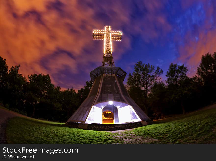 The lighted cross atop of the Mount-Royal in Montreal at night thru a fisheye lens. The lighted cross atop of the Mount-Royal in Montreal at night thru a fisheye lens