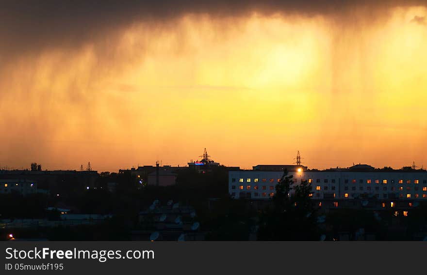 Evening view of the city with rainy clouds. Evening view of the city with rainy clouds