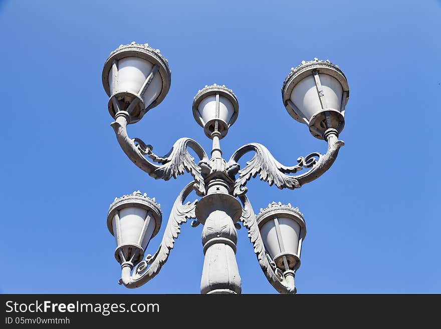 Street retrolamp against the bright blue morning sky. Street retrolamp against the bright blue morning sky