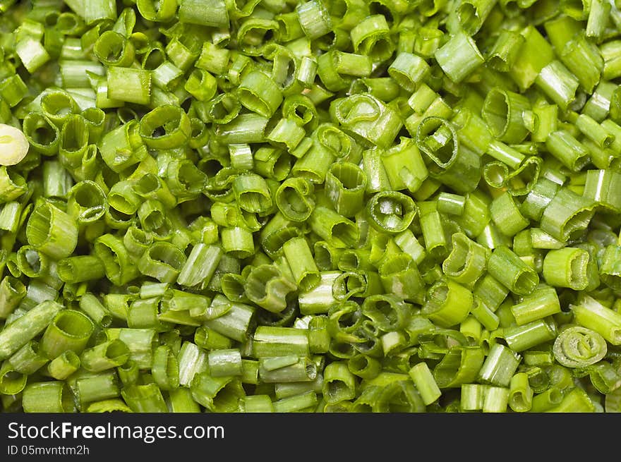 Chopped green onions, or leeks shot from above.