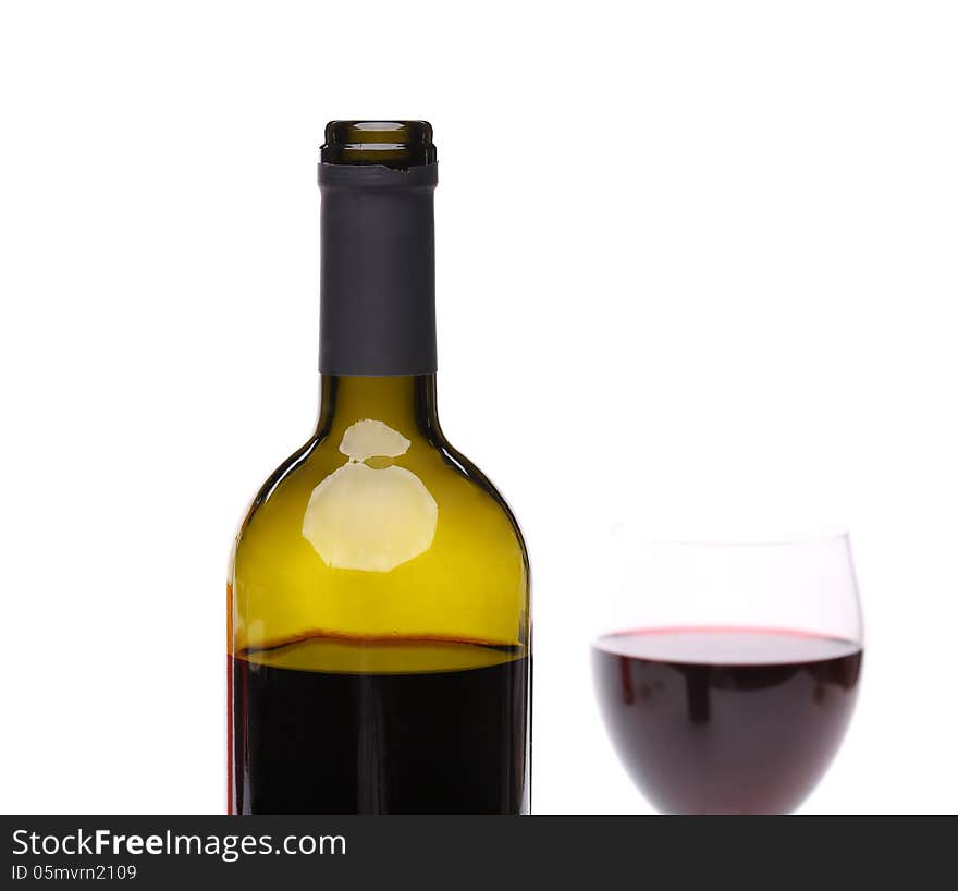 A bottle of red wine and filled with the same level of a wine glass on a white background. A bottle of red wine and filled with the same level of a wine glass on a white background