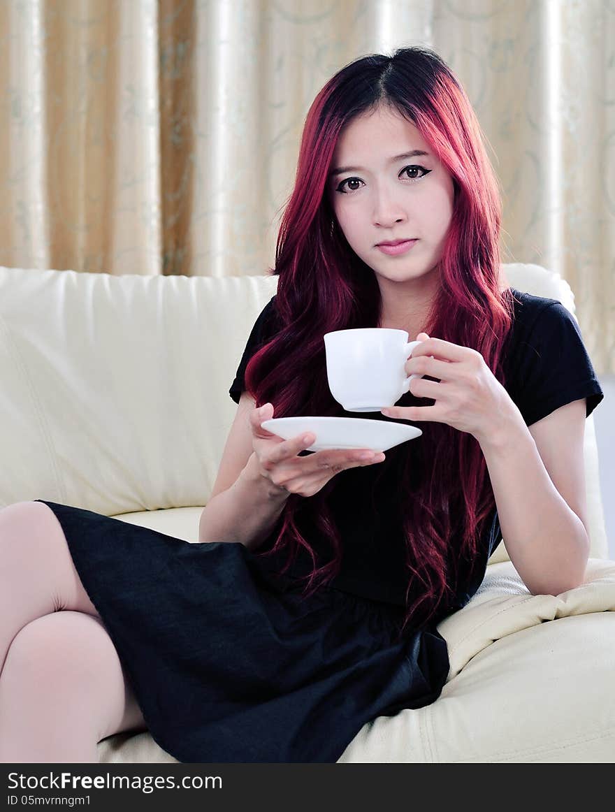 Close up beautiful asian woman with red long hair drinking coffee. Close up beautiful asian woman with red long hair drinking coffee