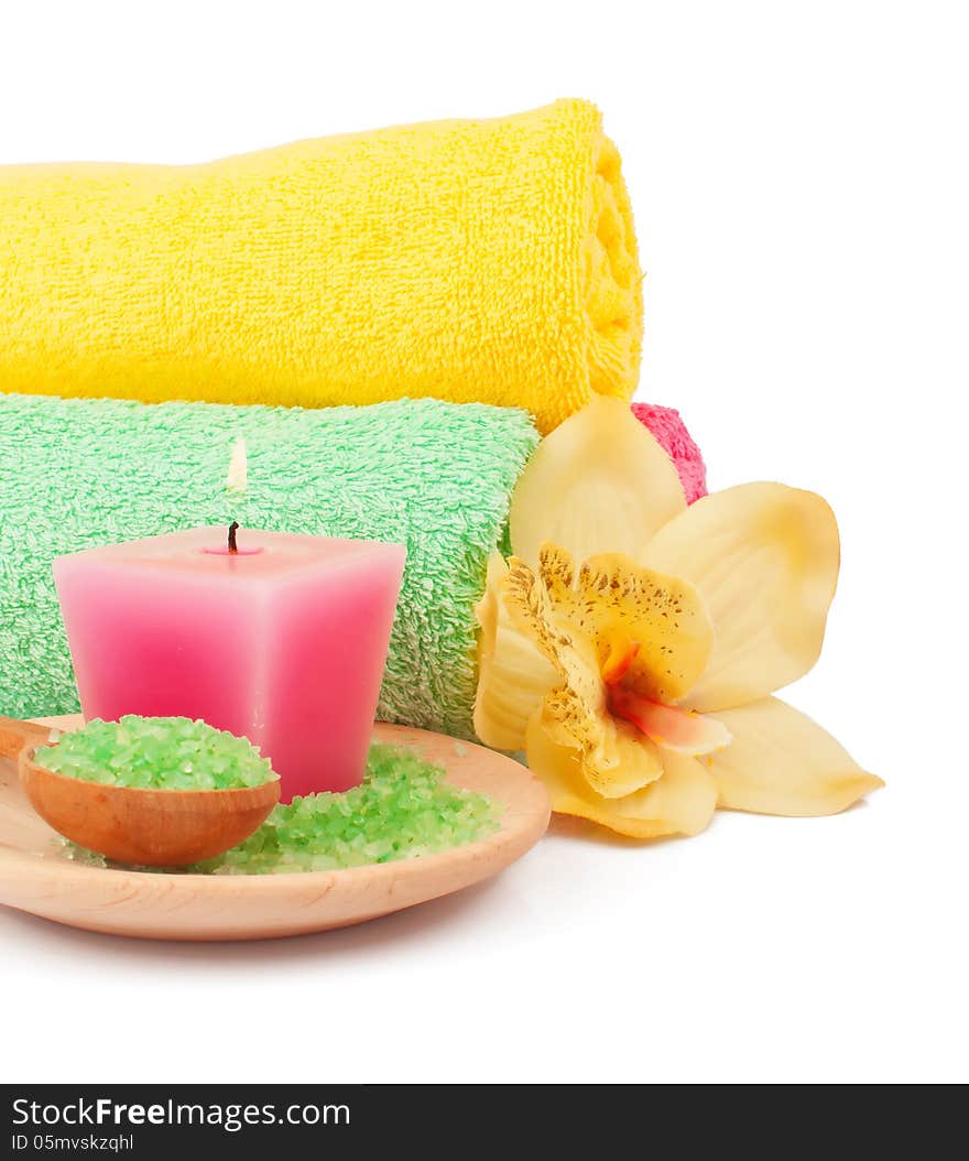 Soft terry towels, bath salts, aroma candle and flowers for spa procedures. Soft terry towels, bath salts, aroma candle and flowers for spa procedures