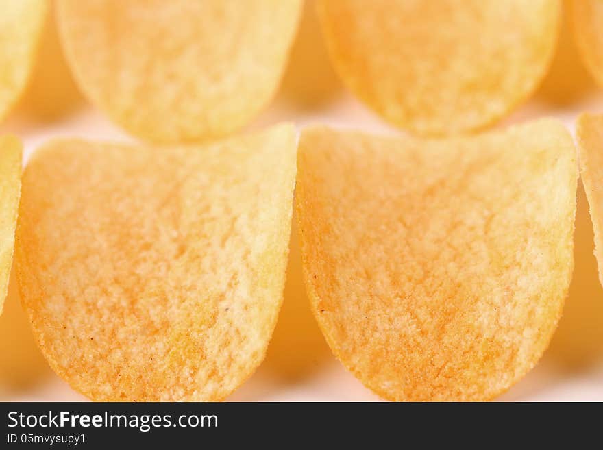 Close-up potato chips as a background. Close-up potato chips as a background