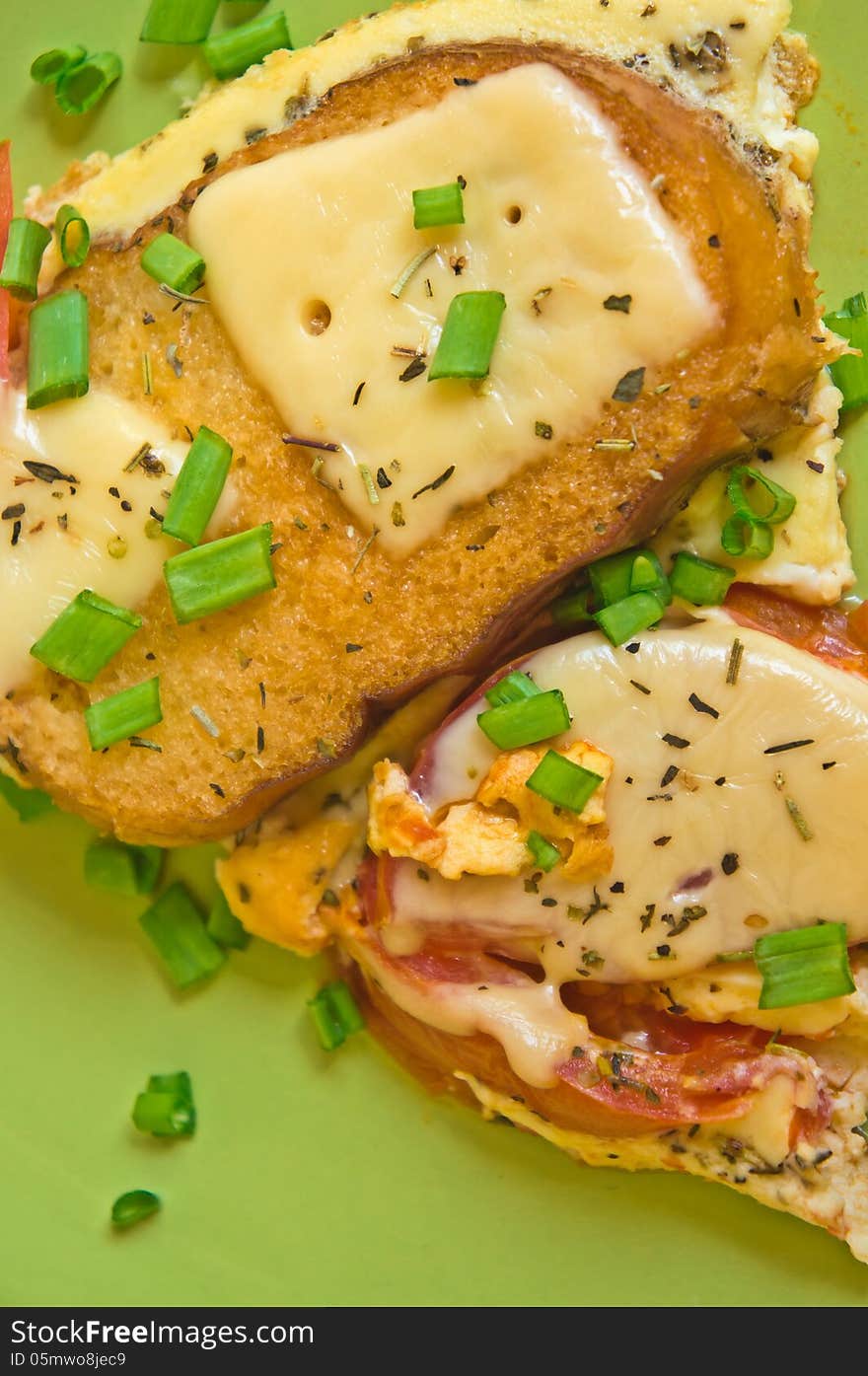 Scrambled eggs with tomato and toast with cheese with herbs and green onions